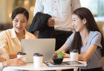 Young Asian woman and business people are meeting in office discussion with colleagues . Group of Business team working and share ideas about project to partners