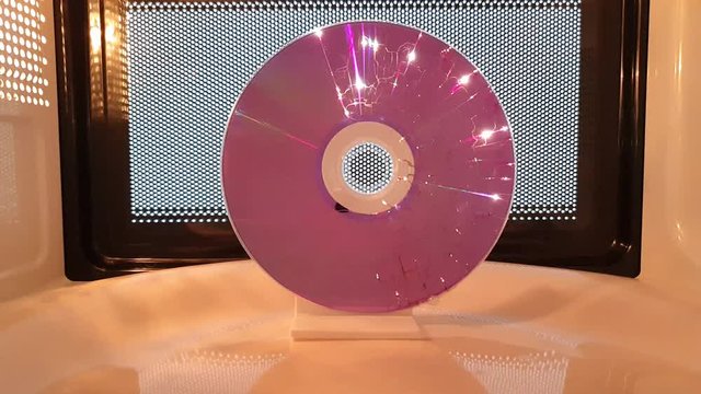 Science project: The death of a disk. The energy from microwave generated electricity in the coating of the CD  until the compact disk melts.