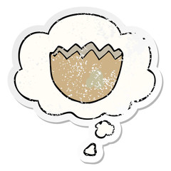 cartoon cracked eggshell and thought bubble as a distressed worn sticker