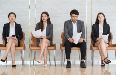 Asian business people are stressed about waiting for a job interview.
