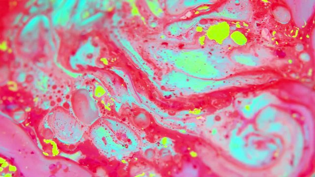 Abstract colorful bubbles background with milk oil . Colored inks react to a drop of liquid soap in the oil 4k
