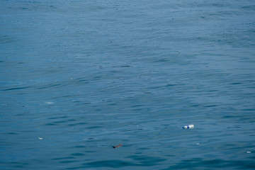 Fototapeta premium Trash, plastic, garbage, bottle... environmental pollution on the beach. Royalty high-quality free stock photo image of trash, plastic bottle on the beach. Waste that polluted the ocean environment
