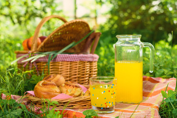 Picnic basket with wine fruit and other products on a natural wooden background. Summer rest . Camping. Picnic in nature.