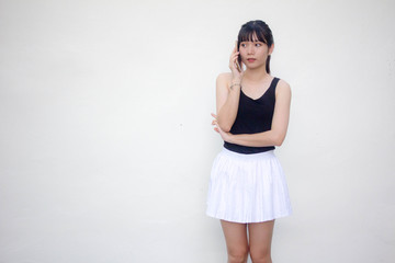 Portrait of thai adult beautiful girl black shirt white skirt calling smart phone