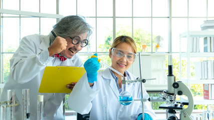 Young female research scientist and Senior male professor researchers working in life scientific laboratory.Young female research scientist and Senior male professor researchers working in life 
