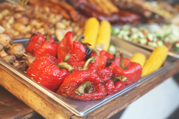 Street food festival, delicious grilled red peppers and other vegetables