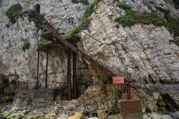 Freshwater Bay: rusty and derelict staircase on a cliff 