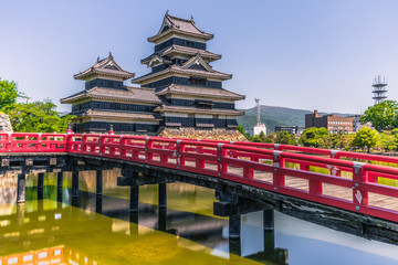 Matsumoto - May 25, 2019: The castle of Matsumoto and the red bridge leading to it, Japan