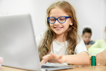 Girl using modern computer during lesson at school
