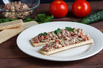 salad with tuna tomato cucumber boiled egg on rice crispbread open sandwiches on plate