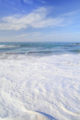 waves on the water of a sandy summer beach