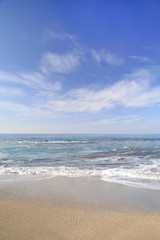 waves on the water of a sandy summer beach