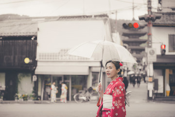 Fototapeta premium Asian woman wearing traditional Japanese kimono walking in the old town of Kyoto, Japan