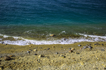 simple scenery landscape photography of sand stone empty waterfront beach of Mediterranean sea vivid blue wavy water surface