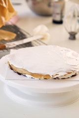 Womon are making in the kitchen.