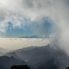 Fototapeta premium clouds over the mountains - view from gran canaria to teneriffa