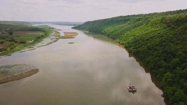 Flying over the river on a sunny summer day. Dniester river of Moldova republic.
