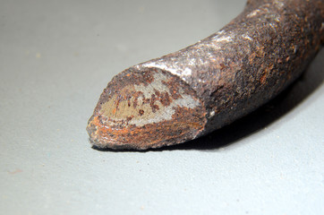 Closeup with focus on the surface of a fracture in a car spring. This spring broke because of metal...