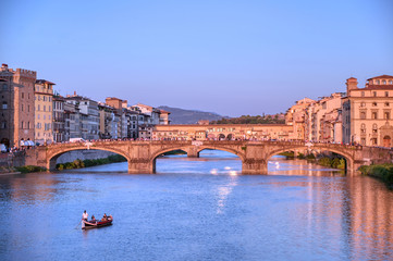 Obraz premium June 6, 2019 - Florence, Italy - A view of the Arno River and the Ponte Vecchio in Florence, Italy.