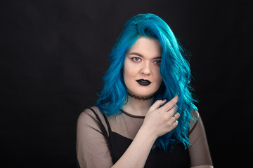 People, style and fashion concept - Close up portrait of young woman with blue long hair dressed in black dress