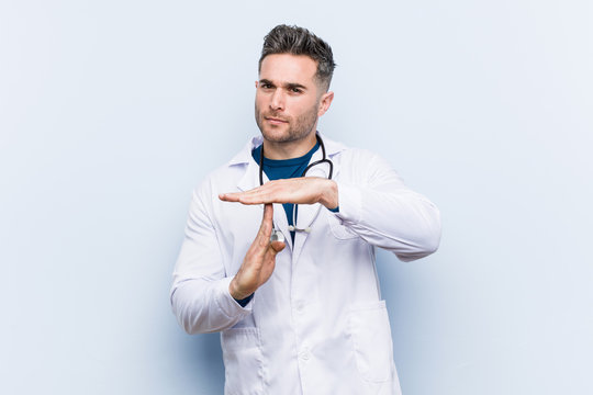 Young Handsome Doctor Man Showing A Timeout Gesture.