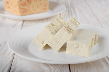 Soy Bean curd tofu on clay dish closeup. Non-dairy alternative substitute for cheese
