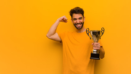 Young man holding a trophy who does not surrender