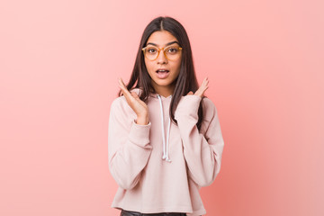 Young pretty arab woman wearing a casual sport look surprised and shocked.