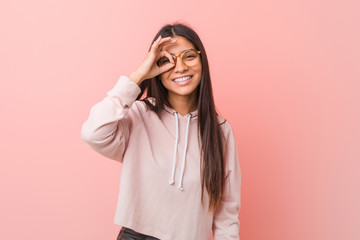 Young pretty arab woman wearing a casual sport look excited keeping ok gesture on eye.