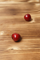 Red sweet cherry scattered on a wooden table