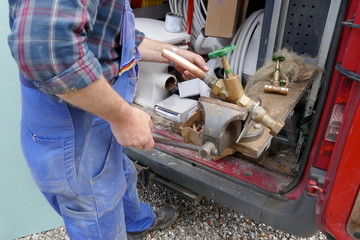 Plumber during the preparation work to install an outdoor faucet.