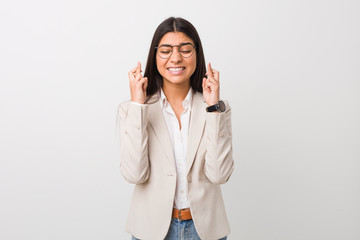 Young business arab woman isolated against a white background crossing fingers for having luck