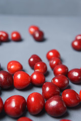 Red sweet cherry scattered on a gray background