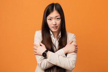 Young business chinese woman going cold due to low temperature or a sickness.