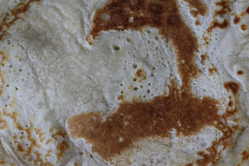 Fresh self baked natural empty pancakes on a white plate on a wooden background