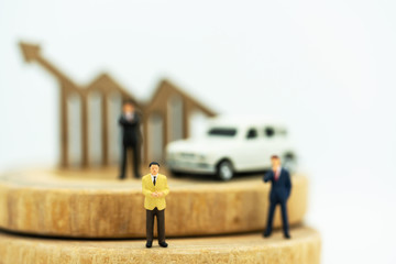 Miniature people:  Businessmen standing on coins stack with graph, Finance, investment and growth in business concept.