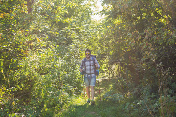 Fototapeta premium Adventures, summer tourism and nature concept - tourist arriving to a camping with his cat