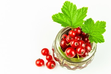 Fresh red currant berries on a white background. Red currant in  bowl with green leaf. Healthy food.
