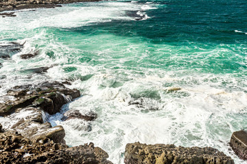 Waves crashing on limestone rocks at Bothar Beach nA hAillite, geoparks geosites, Wild Atlantic Way, wonderful spring day in County Clare in Ireland