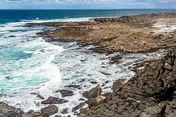 Limestone landscape in Bothar nA hAillite by the sea, Geopark geosites, Wild Atlantic Way, beautiful sunny spring day in County Clare in Ireland