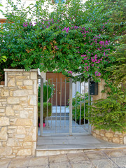 Fototapeta na wymiar stone fence and vintage house main entrance, Athens Greece