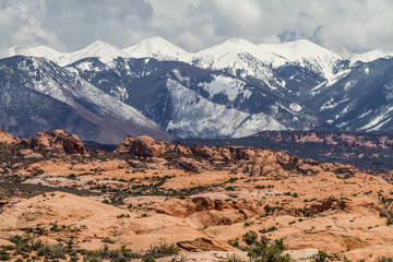 Naklejka na ściany i meble snowy mountains at the bottom of the desert, arches national park