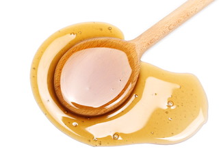 Honey and wooden dipper isolated on white background