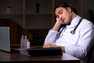 Young male doctor in the hospital at night 