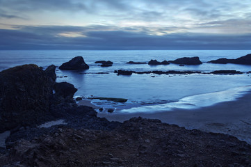 Seascape with rocks and moody blue tones on Oregon coast at Seal Rock Beach