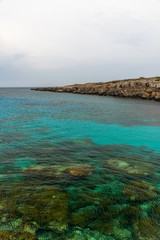 Fototapeta na wymiar The picturesque blue lagoon on the coast of the calm sea.