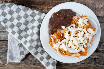 Mexican red chilaquiles with beans and cheese