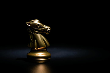 gold knight chess on black background