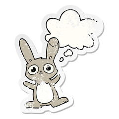 cute cartoon rabbit and thought bubble as a distressed worn sticker