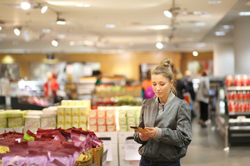 Woman choosing a dairy products at supermarket